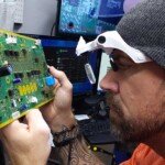 Bassani-Tech-examining-circuit-board